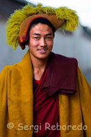 Portrait of a Buddhist monk dressed to go to prayer inside the Tashilumpo Monastery, located in Shigatse, Tibet. Tashilumpo monastery itself is a great city. Built in 1447 has traditionally been the home of the Panchen Lama. It contains many works of art and paintings, thankas, fresh and beautiful carvings.