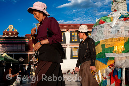Peregrinos junto al templo Jokhang. Lhasa. El templo de Jokhang , de 1300 años de antiguedad, es el centro espiritual de Tíbet. Las oleadas de peregrinos que se postran en el exterior y su característica cúpula dorada son fascinantes. Se construyó encima de un estanque para conmemorar el enlace de la princesa Whencheng, de la dinastía Tang, con el rey Songtsen Gampo. Tal estanque era en realidad, según la princesa, el corazón de una bruja. En la actualidad alberga en su interior una estatua de oro macizo del Buda Sakyamuni que la pincesa ofreció a Tibet, junto con extraordinarios tesoros del arte religiosos tibetano. Se visita mejor por la mañana tempranos; por la tarde se entra por la puerta lateral que queda a la derecha de la principal y las capillas interiores pueden esta cerradas. A menudo, alrededor de las 18.30, se celebran oraciones dirigidas por los monjes en la terraza. Ésta y las salas exteriores permanecen abiertas desde el alba hasta el ocaso.