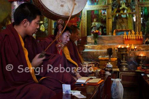Monk praying inside the Tsepak Lhakhang Monastery. Lhasa. Women make a procession around the temple to ask the god of longevity (Cherisi chepal) have a good birth, or elderly people to pray.