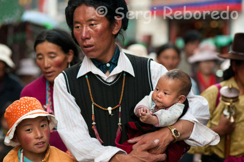Un padre pasea junto a sus hijos por las calles de Lhasa, cerca del templo de Jokhang.