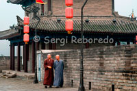 Monks walking down the top of the wall of Xi'an. Although not as famous as others, is the best preserved city wall defending all Chinese cities. It was built between 1374 and 1378 on the Forbidden City of Ming Dynasty and today is still fully in place.
