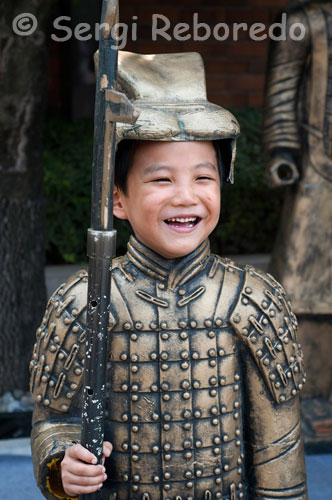 A boy disguised in a suit that mimics the Warriors in Xian Bingmayong archaeological zone, located 35 miles east of the city. The discovery of these warriors, like most archaeological discoveries occurred by chance. It was the spring of 1974, peasants digging a well near Mount Li, when, suddenly, they found fragments of the terracotta statues.