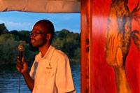 Cruise along the Victoria Falls aboard the " African Queen".  Other boats sailing in the Zambezi River. Upper Zambezi River Cruise is a wonderful way to soak up the atmosphere of this magnificent River.... Lush riverine vegetation, prolific birdlife and abundant game, I would highly recommend this activity especially if you have not done the upper Zambezi canoeing. There are a variety of cruises available early morning, lunch and sunset. There are also a variety of boats from small private boats of 8 to 10 people up to large party boats that carry 120 people. In Zimbabwe the boats launch about 5 Kilometres upstream of the Victoria Falls well out of dangers way of going over the edge, some people are often wary of this. The bigger boats normally head upstream a little way and then turn around to return slowly giving you plenty of time to really take in the magnificence of your surroundings. You will see plenty of crocodiles and hippos and the birdlife is spectacular. Often elephants are seen crossing the river to get to the lush vegetation on the island of the Zambezi River.