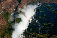 Aerial views of the Victoria Falls. In our minds, there's no better way to get a true sense of the immense scale of Victoria Falls than from the air. When the falls are in high flow (as it was for us), this may be the best way to see the falls as the ground views would be inundated with mist. There are a couple of popular ways to achieve aerial views of the falls - helicopter and microlight/ultralight. Based on our experience, the helicopter ride lasted for about 15 minutes and made several circuits above the falls providing the photographer plenty of opportunities to take decent photos (unless you're the unlucky person in the middle back seat). If you have a DSLR, I highly recommend shooting in servo mode so you can take multiple shots in a short period of time. Unlike helicopter tours in Hawaii or other parts of the world, they don't necessarily seat you based on weight as Julie and I actually got the rear seats during our visit. 