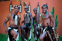 Cultural entertainers black people dressed in authentic naked african warriors in Zambezi Sun Hotel. Located on the edge of the eastern cataract of the Victoria Falls, the Zambezi Sun Hotel reflects the richness and diversity of the country’s heritage; unpretentious, fun and welcoming, it captures the very soul of Africa. From the moment you step inside, expect to be greeted with a warm and friendly atmosphere. Like a glittering gem, The Zambezi Sun Hotel features warm and earthy architecture, inspired by an African village. The simple finishes are highlighted in bright mosaics and fabrics, as well as intoxicating Zambian artworks and accessories. Designed with guest’s comfort and convenience in mind, the Zambezi Sun Hotel is set to turn your stay into a memorable experience. Opened in 2001, the 3-star Zambezi Sun is a sprawling resort hotel with an informal atmosphere, and a colorful, fun design throughout. 