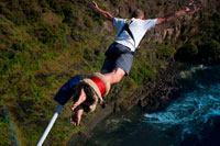 Bungee Jumping at Victoria Falls over Zambezi River. Surely Bungee Jumping 111 meters off the Victoria falls Bridge has to be one of the most challenging, terrifying, crazy things to do. I have not built up the courage yet but from all accounts.... It’s a must do. Thanks to Shearwater, a leading adventure company in Zimbabwe, I got the chance to fulfill my bungee destiny by leaping off the Victoria Falls Bridge. The jump takes you head first into the Batoka Gorge, where white-water rafters below try desperately to stay upright as they ride through grade 5 rapids. The Victoria Falls are situated right behind the bridge and you can feel the spray on the bridge when the water is high. The bridge is in no-man's land, marking the border between Zimbabwe and Zambia. It was built in 1905 and is an engineering marvel (that you get lots of time to appreciate once you've been winched back after your jump). 