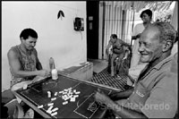 Men in Brazil play domino and talk and discuss about politics, football and community problems. 