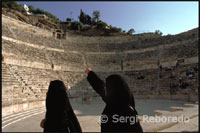 The theatre was built during the reign of Antonius Pius (138-161 CE). The large and steeply raked structure could seat about 6,000 people: built into the hillside, it was oriented north to keep the sun off the spectators.It was divided into three horizontal sections (diazomata). Side entrances (paradoi) existed at ground level, one leading to the orchestra and the other to the stage. Rooms behind these entrances now house the Jordanian Museum of Popular Traditions on the one side, and the Amman Folklore Museum on the other side. The highest section of seats in a theatre was (and still is) called "The Gods". Although far from the stage, even there the sightlines are excellent, and the actors could be clearly heard, owing to the steepness of the cavea. (169-177 AD), the large and steeply raked theatre could seat about 6,000 people. It is built into the hillside, and oriented north to keep the sun off the spectators. In this photo, the orchestra and stage are viewed from the first diazoma (horizontal division) of the cavea. 