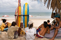 Kuta Beach. While some tourists decide to surf other resting on the sand. Bali.