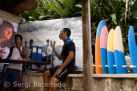 Instructors surf on the beach at Kuta. Bali.