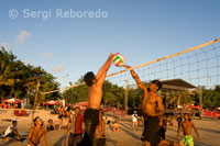 Some people take advantage of the evening to play volleyball on the beach of Kuta. Bali.
