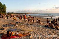 At dusk everyone gathers to watch the sunset, taking a beer on the beach of Kuta. Bali. Indonesia.