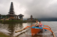 A couple of wedding photos done in a boat on the lake next to the Brat important temple Pura Ulan Danu Brat. Central mountains of Bali.