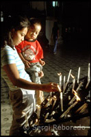 Placing candles at the Cathedral of St. Paul. Vigan. Ilocos.