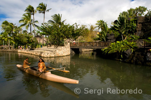 Canoe sailing through the canal that runs through the park. Polynesian Cultural Center. O'ahu. O'AHU, THE MYTHICAL ISLAND IN HONOLULU WAIKIKI BEACH. In the days when the chief Kamehameha I arrived on the island, back in 1795, Waikiki was a large fish pond shared with farm fields where cultivated taro, a Polynesian typical plant very much in Hawaiian cuisine.